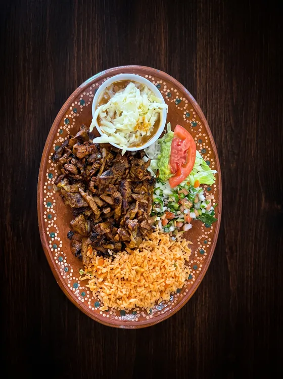 Chopped grilled beef with rice, pico de gallo, lettuce, tomato and a small cup of shredded cabbage.