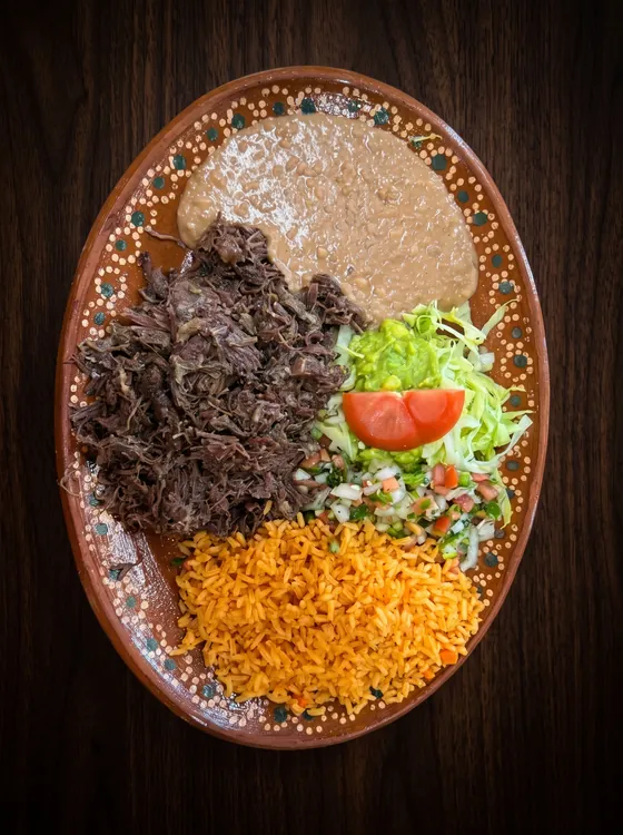 Shredded slow-cooked beef with rice, refried beans, guacamole, pico de gallo, lettuce and tomato.